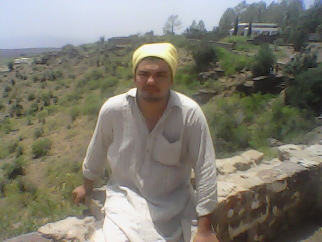 Khan was sitting on the wall of park